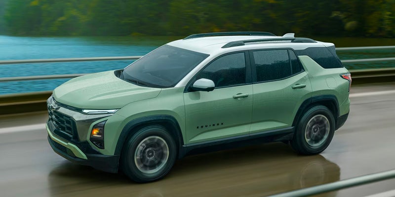 2026 Chevrolet Equinox ACTIV green SUV driving near water