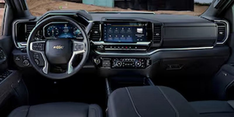 Chevrolet Silverado 2500 HD interior with digital instrument cluster and steering wheel controls.