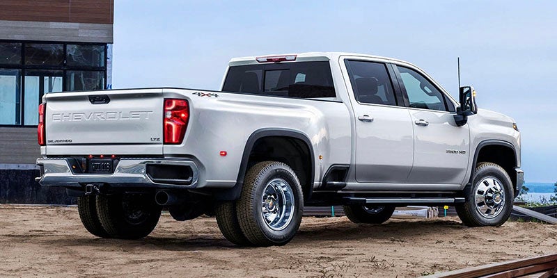 White Chevrolet Silverado 2500 HD pickup truck parked on a paved surface.