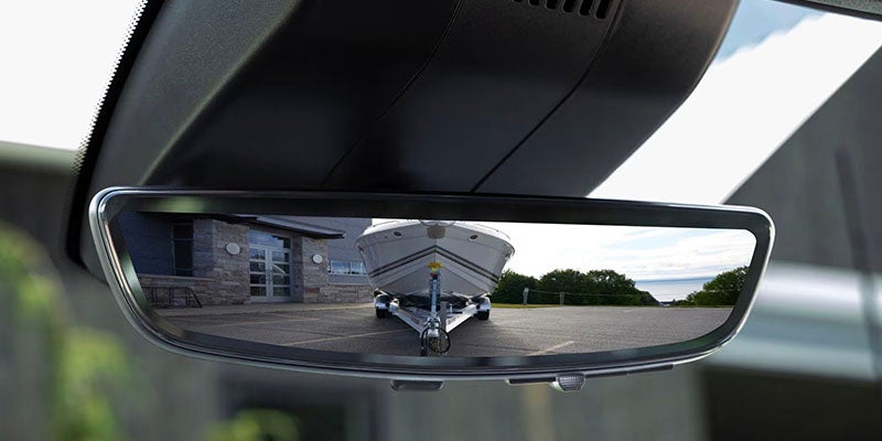 Chevrolet Silverado 2500 HD rearview mirror displaying a trailer view for towing assistance.