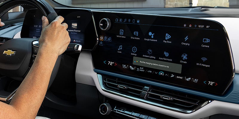 Chevrolet Equinox interior infotainment screen with climate controls and driver interaction.